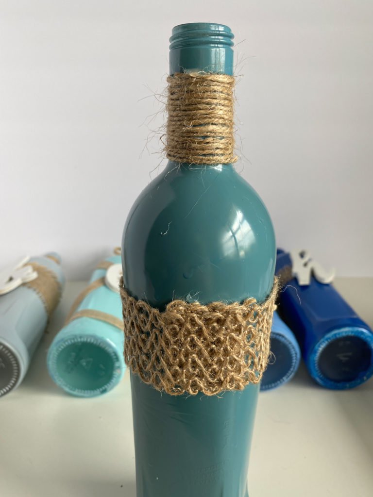 Twine is glued to neck of bottle