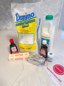 Icing ingredients: bag of confectioner's sugar, milk, vanilla & almond extracts, stick of unsalted butter, stick of shortening, Wilton 1M decorating tip, Wilton Sky Blue Icing Color, and textured disposable decorating bag