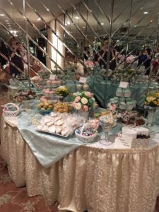 Sweets Table with assorted cupcakes decorated with buttercream roses and assorted pastries