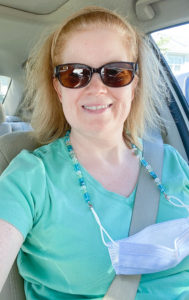 Wearing seaglass colored mask chain in car with seatbelt on, and mask and chain draped over the seatbelt.