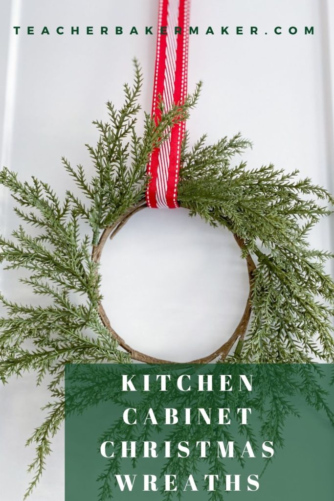 Pinterest image of green wreath hung with red and white ribbon on white cabinet door with green text overlay box of Kitchen Cabinet Christmas Wreaths