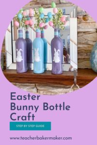 Pinterest Pin image of 3 Easter bunny bottles on mantle in front of mirror, 2 glitter purple bottles 1 gloss blue bottle with Easter egg sprays and cotton ball tails