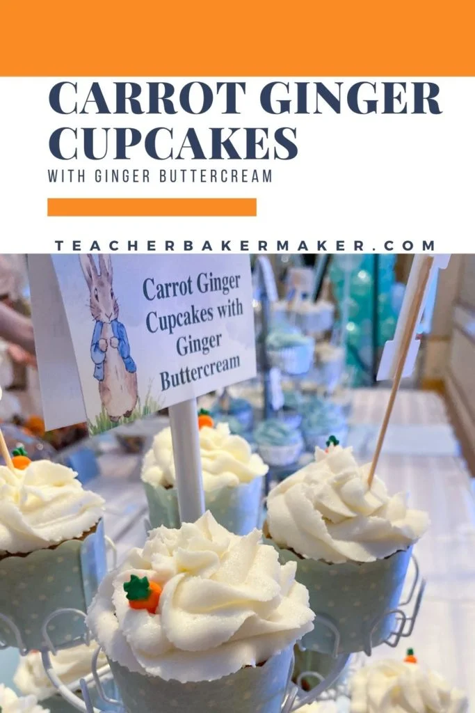 Display of carrot ginger cupcakes in light blue baking cups with white dots and Peter Rabbit sign labeled carrot ginger cupcakes with ginger buttercream