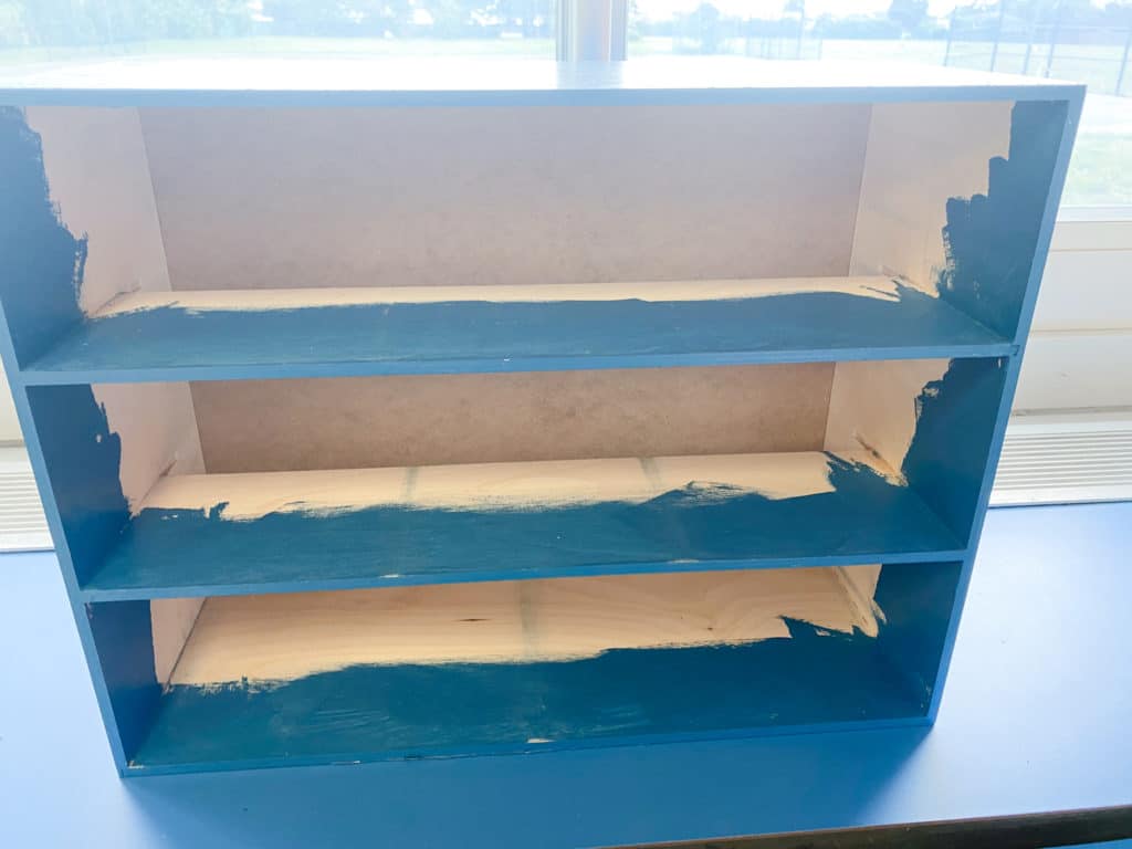 Interior of Ikea Moppe teacher toolbox partially painted in Behr semi-gloss bering wave blue