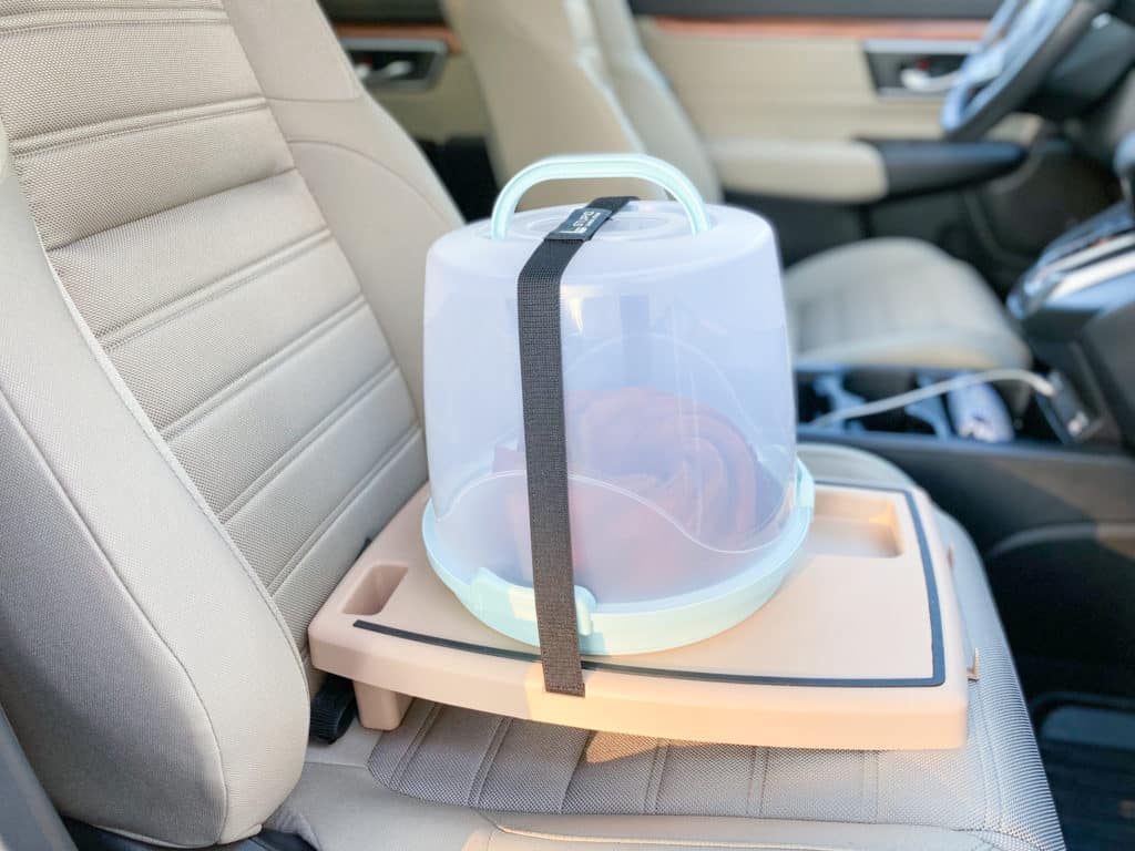 Tall cake carrier on Stupid Car Tray in Desert Night color on ivory car seat