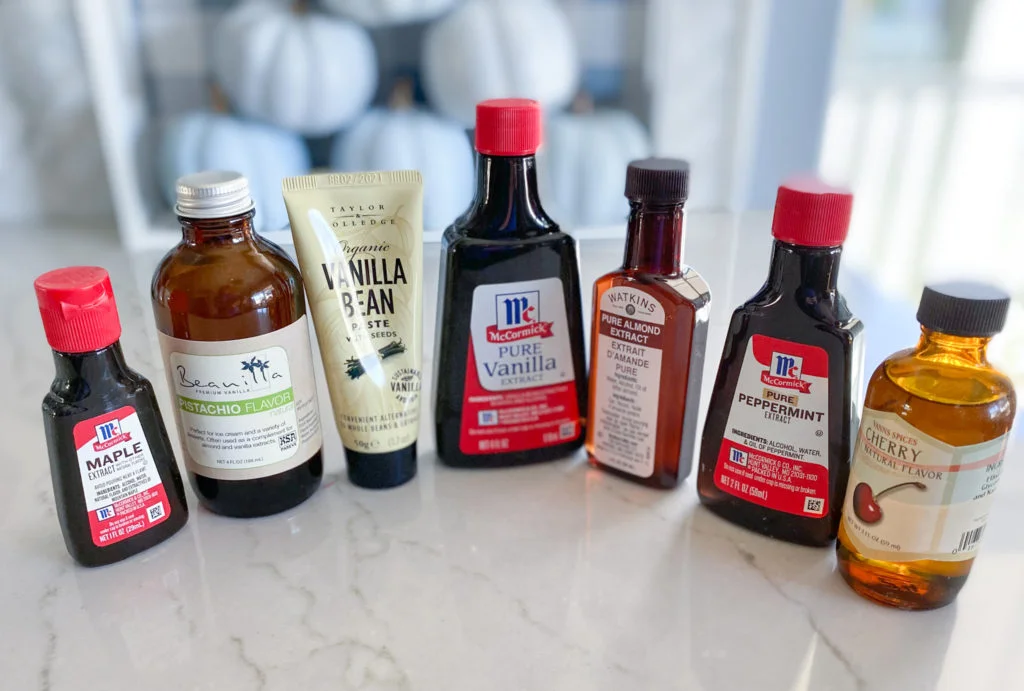 bottles of maple extract, pistachio extract, vanilla bean paste in a tube, vanilla extract, almond extract, peppermint extract, and cherry flavoring to doctor up a cake mix