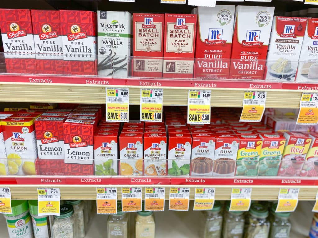 Grocery store shelves of vanilla extracts and flavored extracts