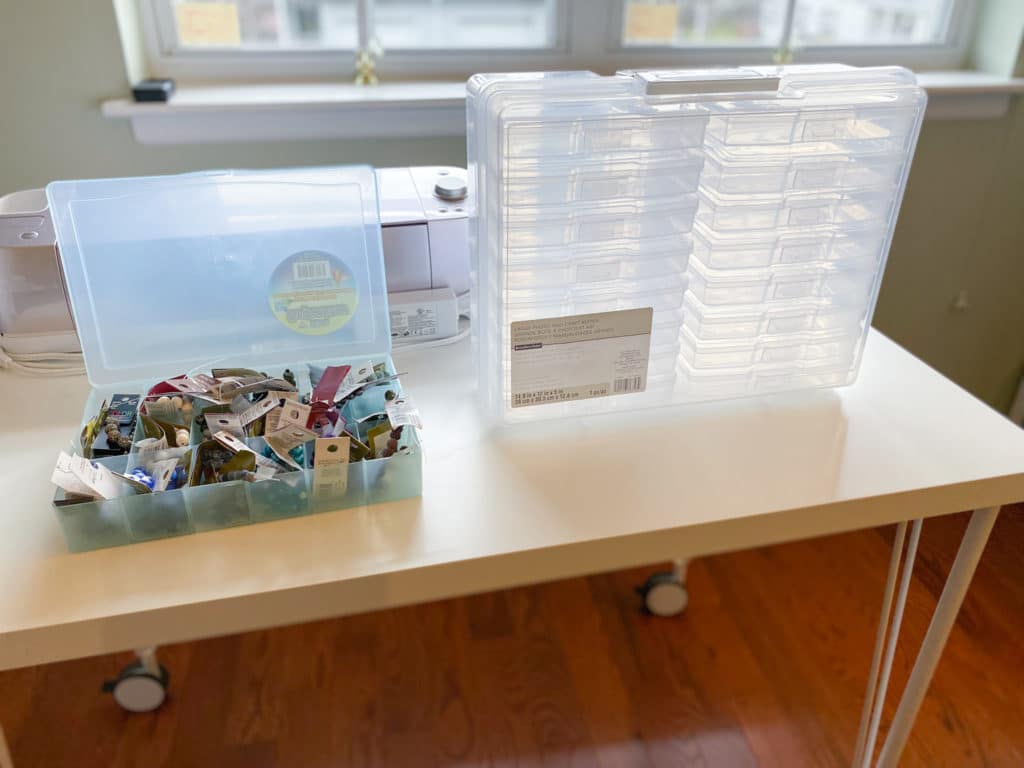 Bead storage in embroidery floss box next to empty clear plastic photo storage box