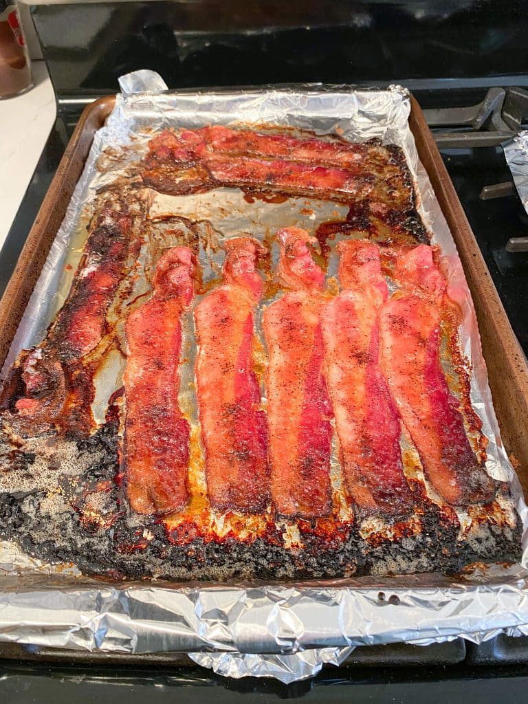 cooked candied bacon on foil lined baking sheet
