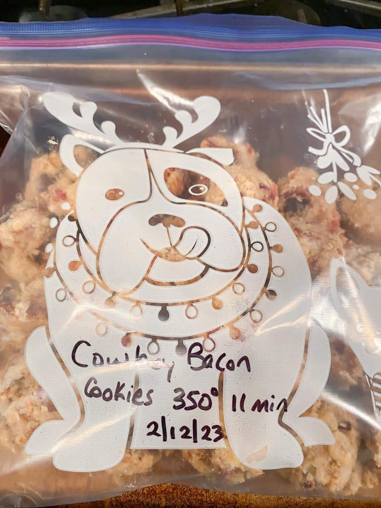 zippered freezer bag labeled cowboy bacon cookies 350 degrees 11 minutes, with bacon chocolate chip cookie dough balls
