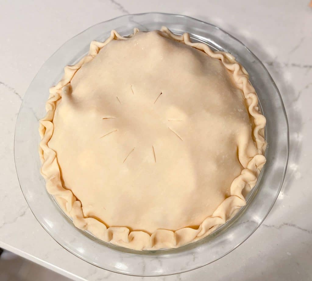 freezer apple pie with top crust and fluted edge and slits cut around center of top crust, pre-baked