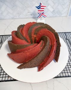 cooling rack with red and blue bundt cake on white cake circle with red white and blue star in background