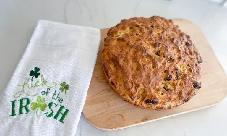 Irish soda bread on cutting board with Luck of the Irish towel